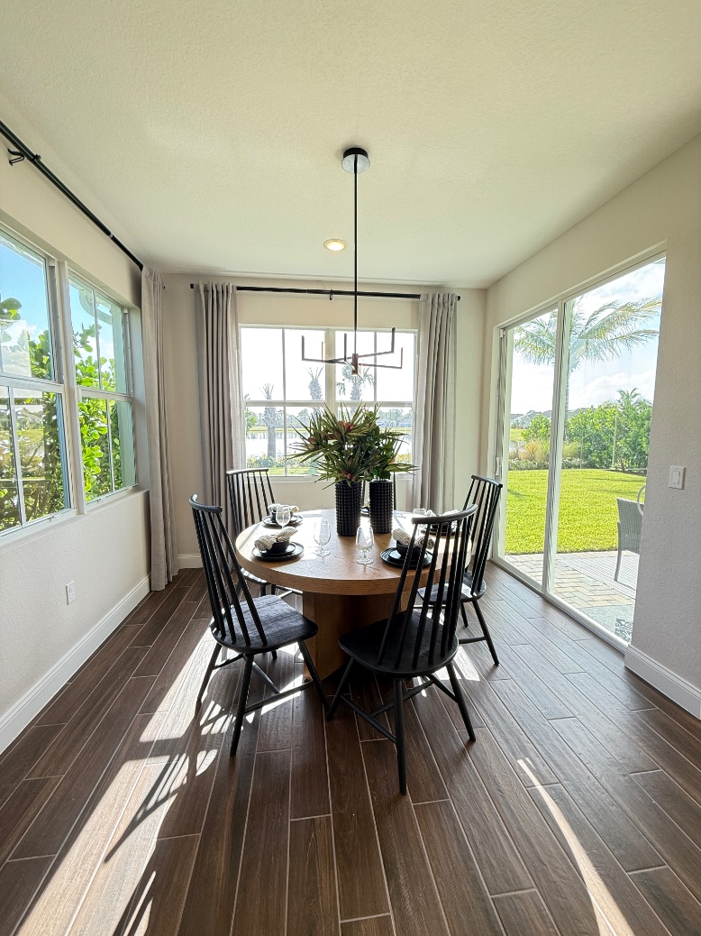 Astaire Dining Room | Four Seasons at Wylder K. Hovnanian Astaire Model Dining Room - Open concept dining area with sliding door to covered patio at Four Seasons at Wylder, Port St. Lucie