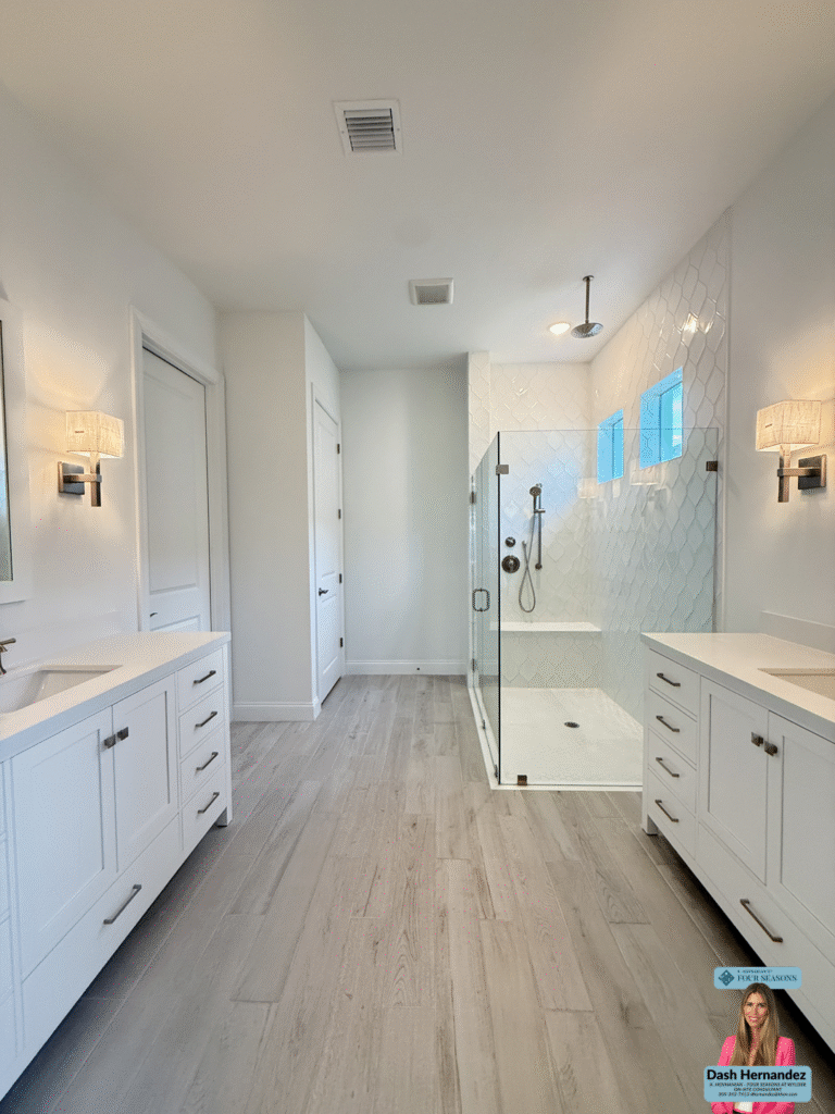 Elegant bathroom with sink, mirror, and tub in K Hovnanian 55 plus community Port St Lucie